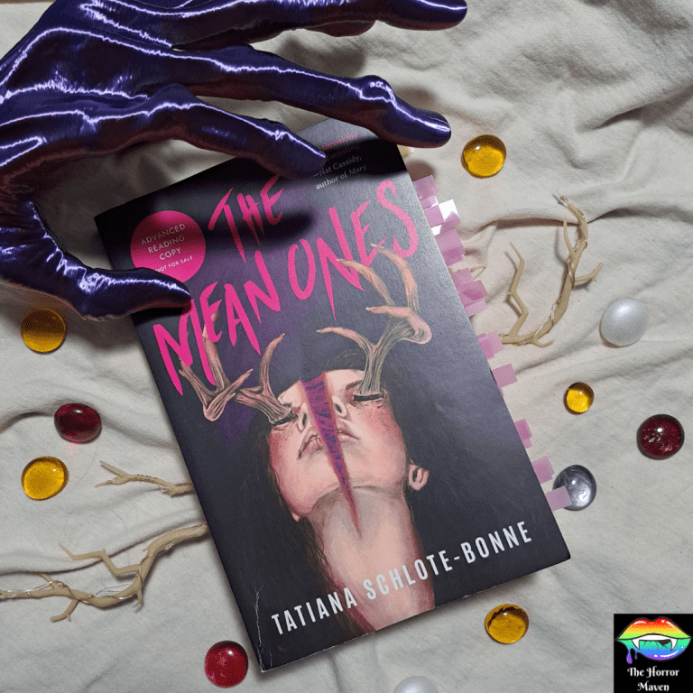 A stylized picture featuring an advanced copy of the book, The Mean Ones by Tatiana Schlote-Bonne