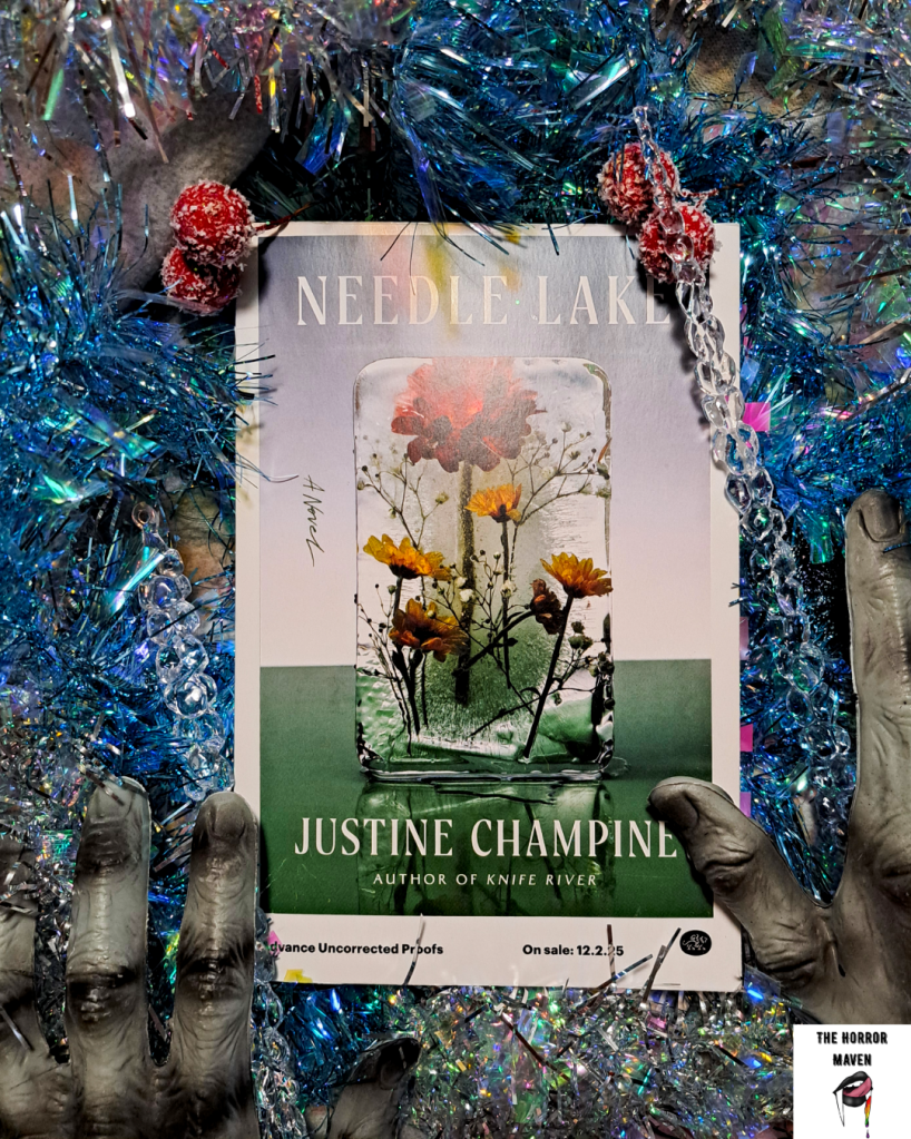 A stylized image that features an advanced copy of "Needle Lake" by Justine Champine surrounded with fake dead hands, berries, icicles, and shiny blue tinsel.